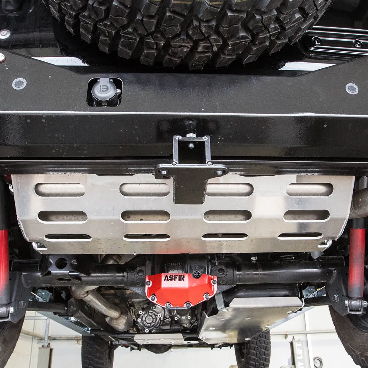 ASFIR skid plate and red differential guard under a truck